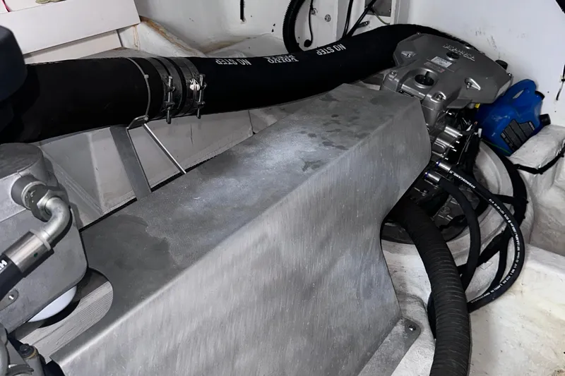 Uni Yacht Photos Pics Engine compartment of a 2020 Fjord 44 Open boat, showcasing mechanical components and hoses.
