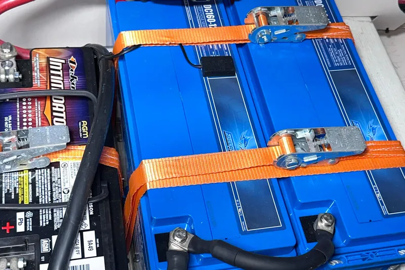 Uni Yacht Photos Pics Battery setup in a 2020 Fjord 44 Open boat, featuring secured blue and black batteries.