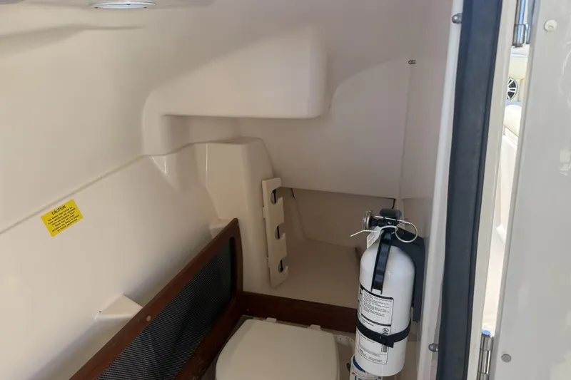 275-264 Brokerage Joe Yacht Photos Pics 2022 Grady-White Freedom 275 interior with fire extinguisher and storage area.