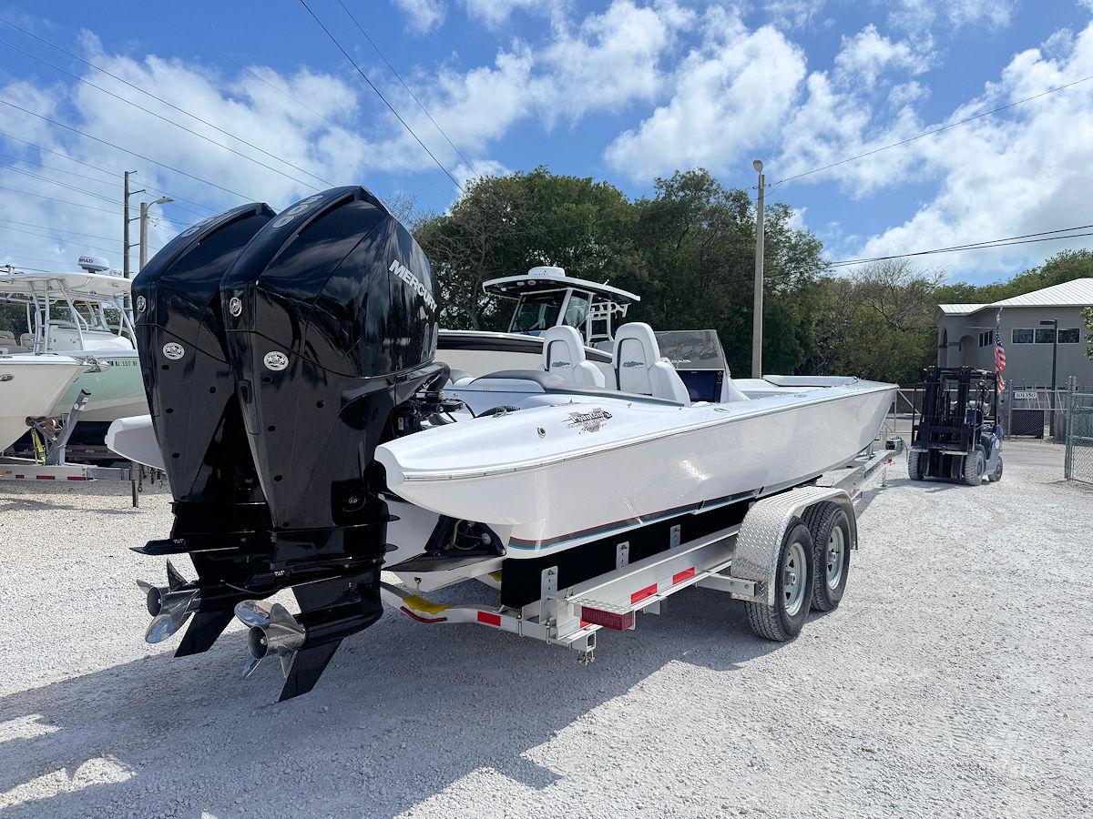 2022 Phantom 32 CC boat on trailer with dual outboard engines, parked outdoors.