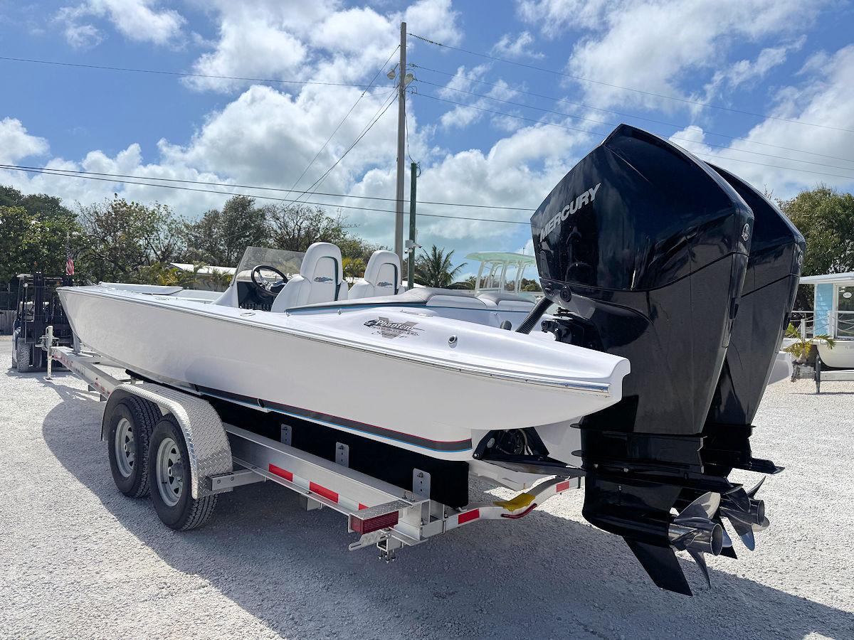 2022 Phantom 32 CC boat on trailer with dual Mercury engines, parked outdoors.