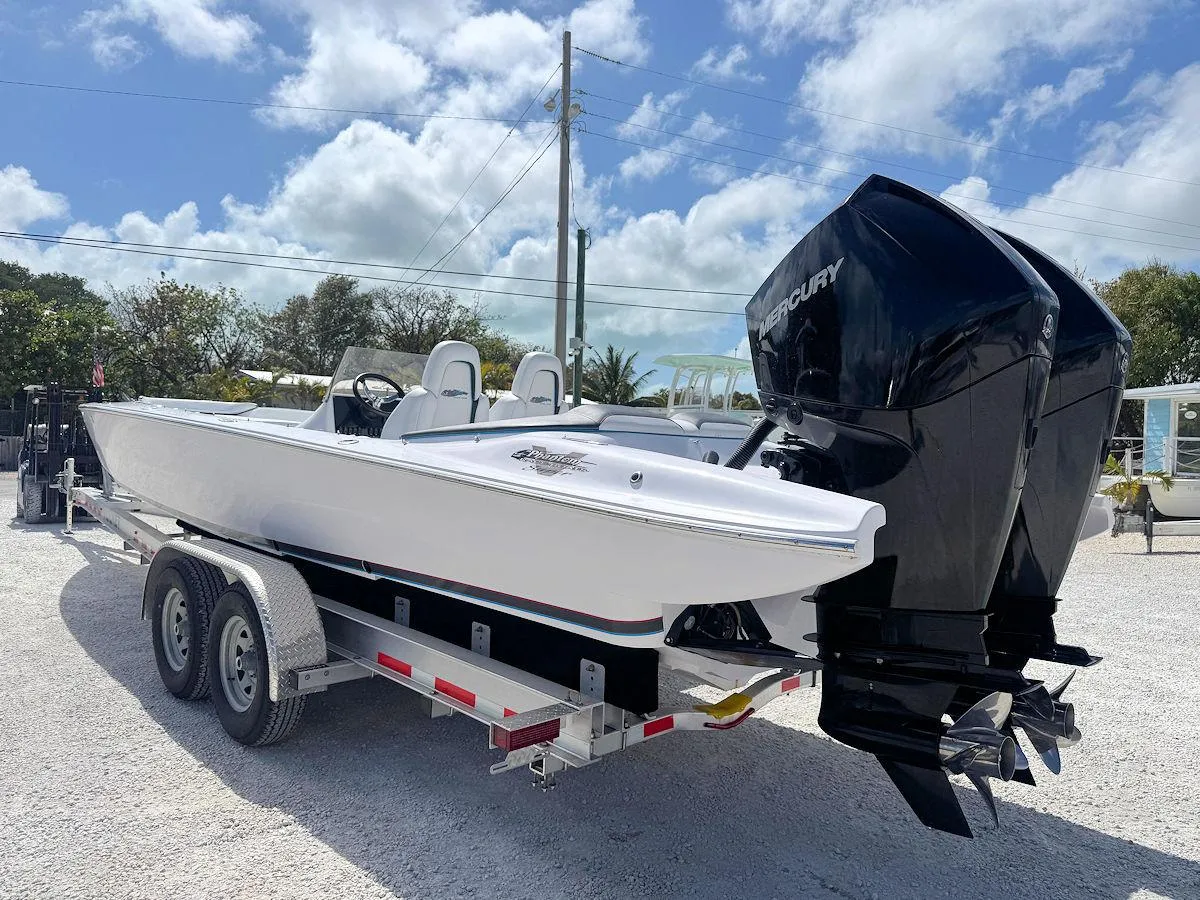 2022 Phantom 32 CC boat on trailer with dual Mercury engines, parked outdoors.
