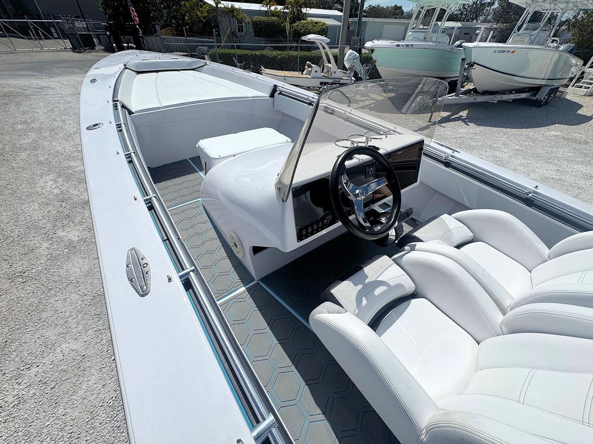 2022 Phantom 32 CC boat interior with white seating and steering console.