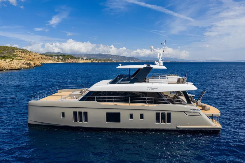 Vahewa Yacht Photos Pics 2024 Sunreef Power Cat yacht cruising on a clear blue sea under a bright sky.