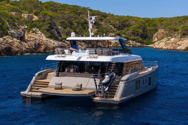 Vahewa Yacht Photos Pics 2024 Sunreef Power Cat yacht anchored in a scenic coastal bay.