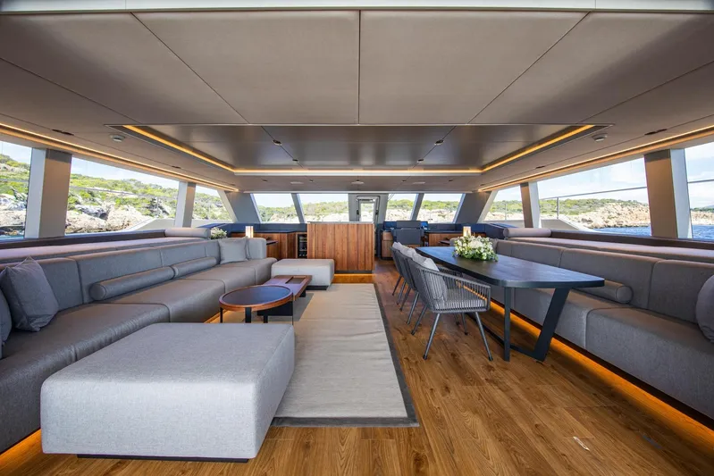 Vahewa Yacht Photos Pics Luxurious interior of 2024 Sunreef Power Cat yacht with modern seating and dining area.