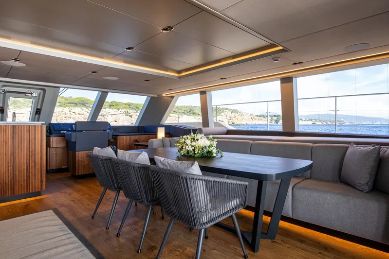 Vahewa Yacht Photos Pics Luxurious interior of 2024 Sunreef Power Cat yacht with elegant dining area and panoramic windows.