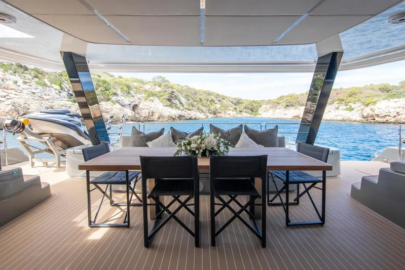 Vahewa Yacht Photos Pics Luxurious 2024 Sunreef Power Cat yacht deck with elegant dining area and scenic ocean view.