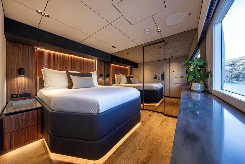 Vahewa Yacht Photos Pics Luxurious 2024 Sunreef Power Cat cabin with modern design, large bed, and scenic window view.