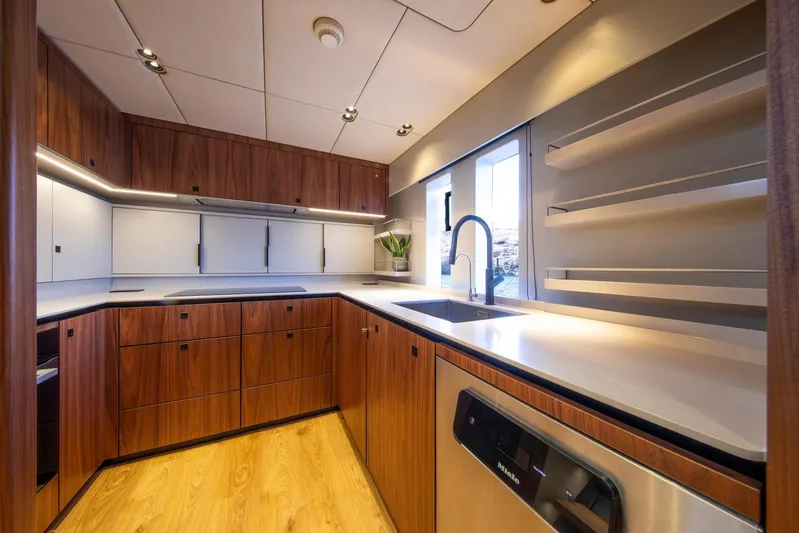 Vahewa Yacht Photos Pics Luxurious kitchen interior of 2024 Sunreef Power Cat yacht with modern wood cabinetry.