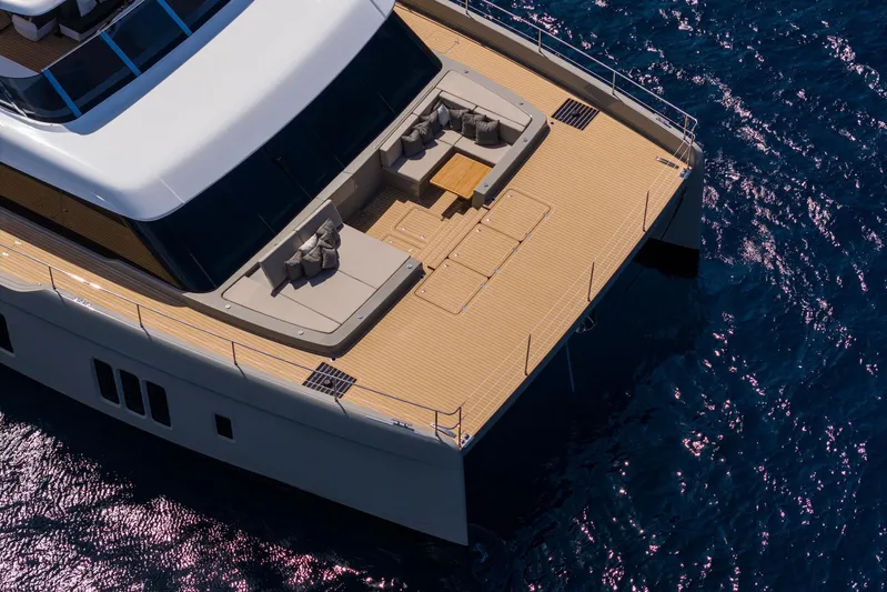 Vahewa Yacht Photos Pics 2024 Sunreef Power Cat yacht with spacious deck and luxurious seating on blue ocean.