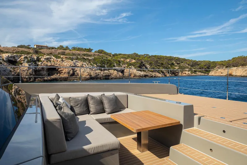 Vahewa Yacht Photos Pics Luxurious 2024 Sunreef Power Cat yacht deck with seating, overlooking scenic coastal view.