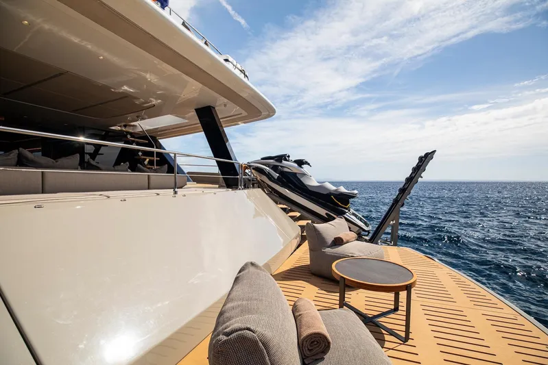 Vahewa Yacht Photos Pics Luxurious 2024 Sunreef Power Cat yacht deck with ocean view and jet skis.