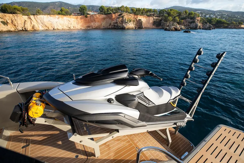 Vahewa Yacht Photos Pics 2024 Sunreef Power Cat with jet ski on deck, scenic coastal backdrop.