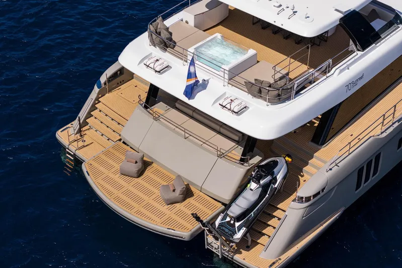 Vahewa Yacht Photos Pics Luxurious 2024 Sunreef Power Cat yacht with spacious deck, jacuzzi, and jet ski, cruising on blue waters.