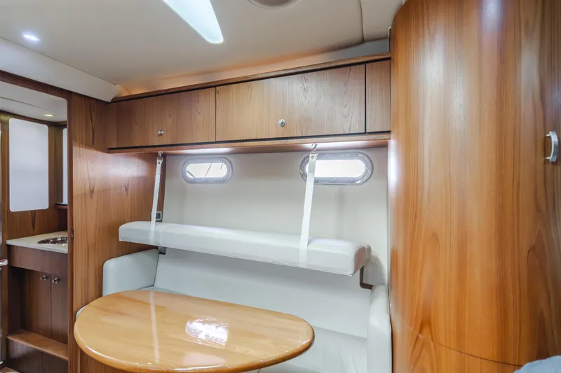 Niksen Yacht Photos Pics 2013 Tiara Yachts 3500 Sovran interior with wooden cabinetry and dining area.