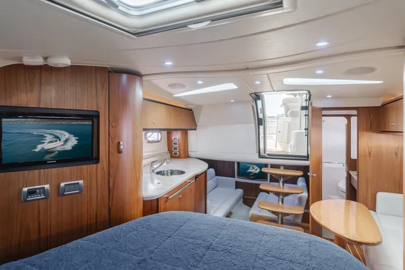 Niksen Yacht Photos Pics 2013 Tiara Yachts 3500 Sovran interior with wood finish, kitchenette, and seating area.