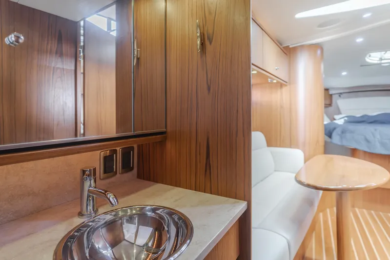 Niksen Yacht Photos Pics Interior of 2013 Tiara Yachts 3500 Sovran, featuring wood cabinetry and modern sink.