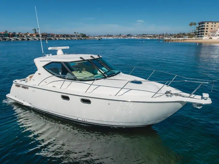 Niksen Yacht Photos Pics 2013 Tiara Yachts 3500 Sovran cruising in a scenic coastal area.