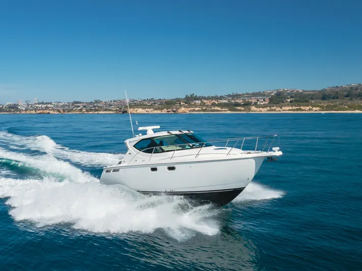 Niksen Yacht Photos Pics 2013 Tiara Yachts 3500 Sovran cruising on open water under clear blue skies.