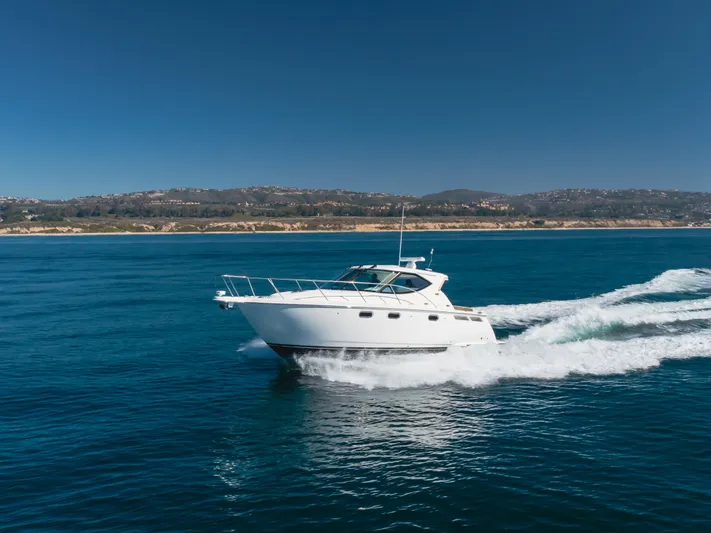 Niksen Yacht Photos Pics 2013 Tiara Yachts 3500 Sovran cruising on open water under clear blue skies.