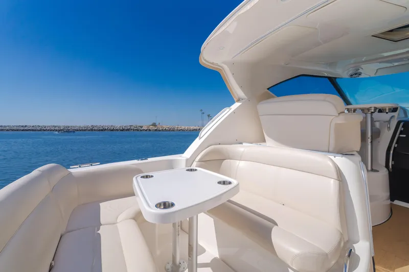 Niksen Yacht Photos Pics 2013 Tiara Yachts 3500 Sovran interior with seating and table, overlooking calm waters.