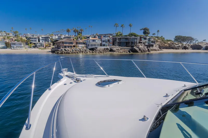 Niksen Yacht Photos Pics 2013 Tiara Yachts 3500 Sovran cruising near coastal homes under clear blue skies.