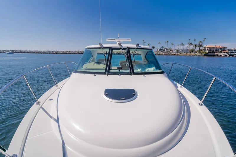 Niksen Yacht Photos Pics 2013 Tiara Yachts 3500 Sovran on calm water, clear sky, coastal background.