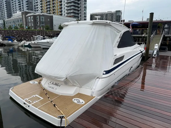 Bubbles Yacht Photos Pics 2016 Regal 35 Sport Coupe docked at marina with cityscape background.
