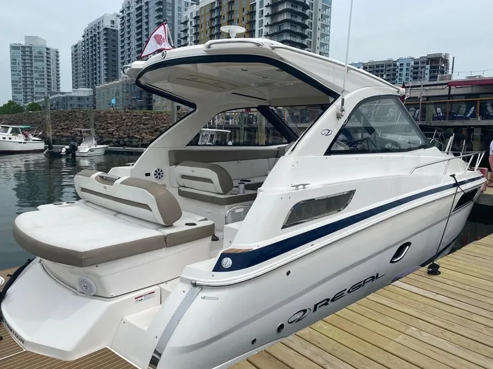 Bubbles Yacht Photos Pics 2016 Regal 35 Sport Coupe docked at marina with cityscape background.