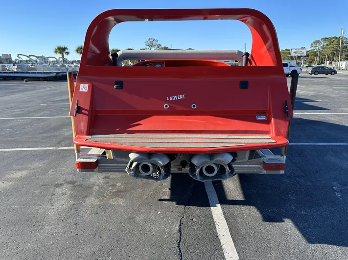 Scream Machine Yacht Photos Pics Red 2016 Smoky Mountain 25 Passenger Jet Boat parked in a lot, rear view.