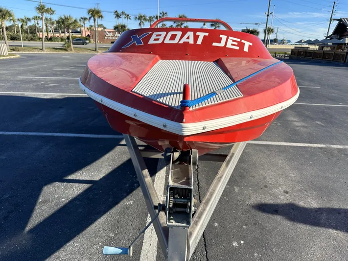Scream Machine Yacht Photos Pics Red Smoky Mountain 25 Passenger Jet Boat, 2016 model, parked on a trailer in a lot.