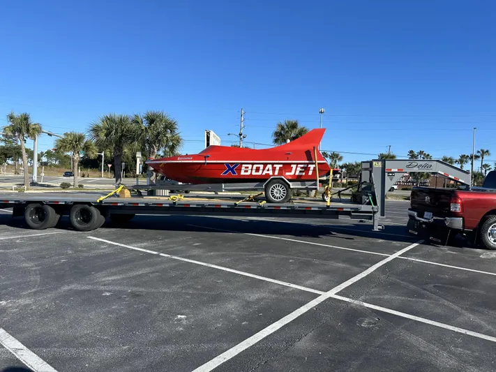 Scream Machine Yacht Photos Pics Red Smoky Mountain 25 Passenger Jet Boat on trailer in parking lot, 2016 model.
