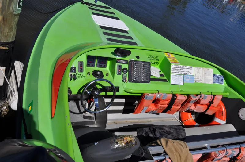 Scream Machine Yacht Photos Pics 2016 Smoky Mountain 25 Passenger Jet Boat, green, docked, with life jackets and control panel.