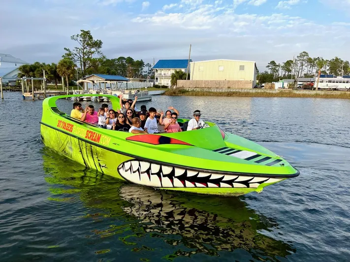 Scream Machine Yacht Photos Pics Bright green 2016 Smoky Mountain 25 Passenger Jet Boat with passengers on a scenic waterway.