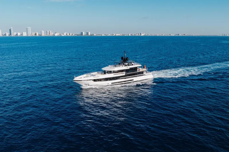 Half Irish Yacht Photos Pics 2024 Mangusta Oceano 44 yacht cruising on open sea near city skyline.
