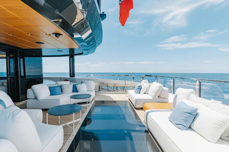 Half Irish Yacht Photos Pics Luxurious 2024 Mangusta Oceano 44 yacht deck with plush seating and ocean view.