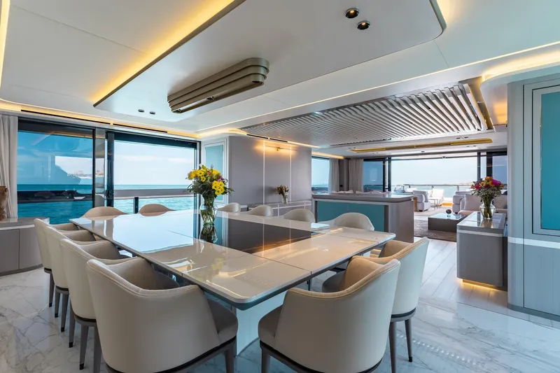 Half Irish Yacht Photos Pics Luxurious interior of 2024 Mangusta Oceano 44 yacht with elegant dining area and ocean view.