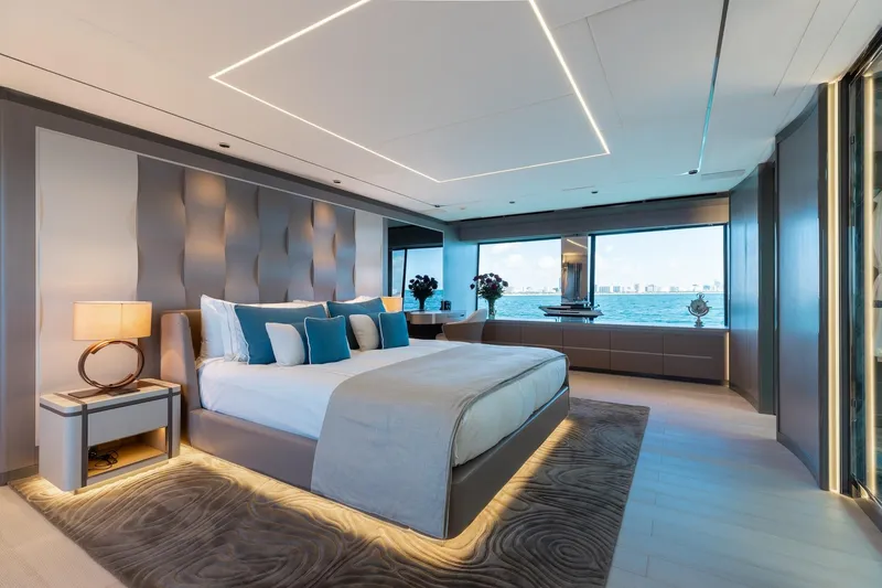 Half Irish Yacht Photos Pics Luxurious bedroom on 2024 Mangusta Oceano 44 yacht with ocean view and modern decor.