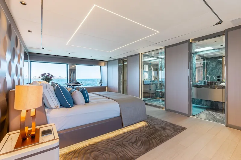 Half Irish Yacht Photos Pics Luxurious bedroom interior of 2024 Mangusta Oceano 44 yacht with ocean view.