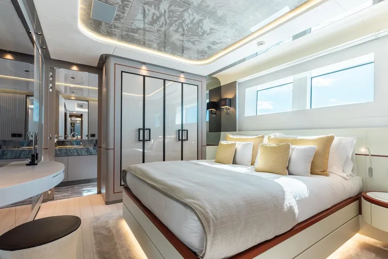 Half Irish Yacht Photos Pics Luxurious bedroom interior of 2024 Mangusta Oceano 44 yacht, featuring elegant design and modern amenities.