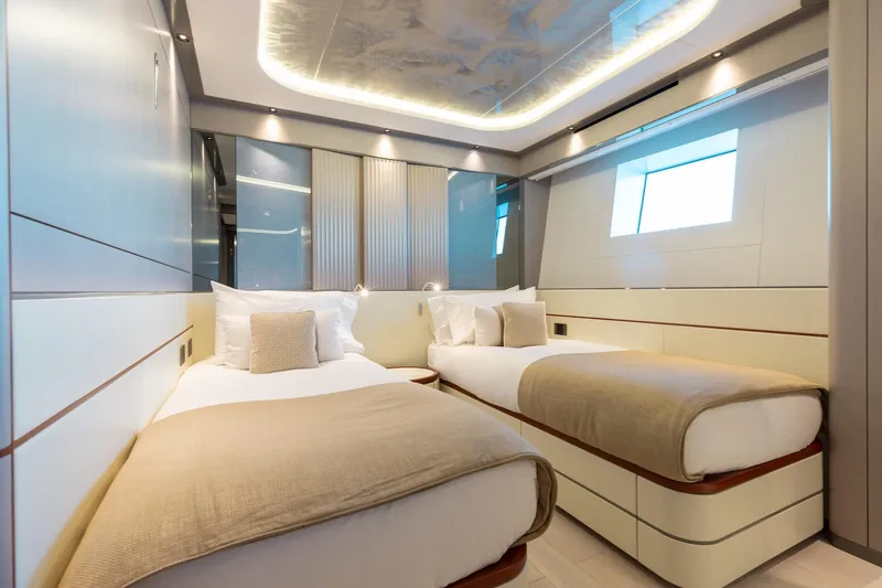 Half Irish Yacht Photos Pics Luxurious twin cabin interior of 2024 Mangusta Oceano 44 yacht, featuring modern design and ambient lighting.