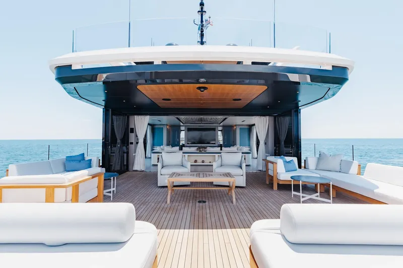 Half Irish Yacht Photos Pics Luxurious 2024 Mangusta Oceano 44 yacht deck with elegant seating and ocean view.