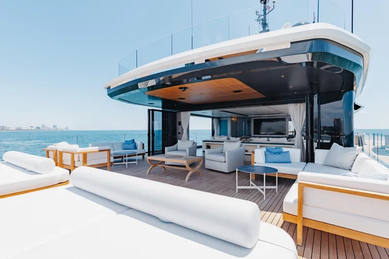 Half Irish Yacht Photos Pics Luxurious 2024 Mangusta Oceano 44 yacht deck with elegant seating and ocean view.