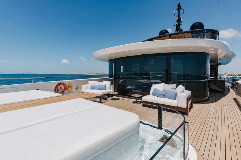 Half Irish Yacht Photos Pics Luxurious 2024 Mangusta Oceano 44 yacht deck with modern seating and ocean view.