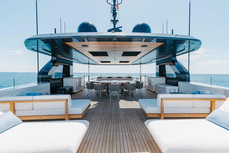 Half Irish Yacht Photos Pics Luxurious 2024 Mangusta Oceano 44 yacht deck with elegant seating and ocean view.
