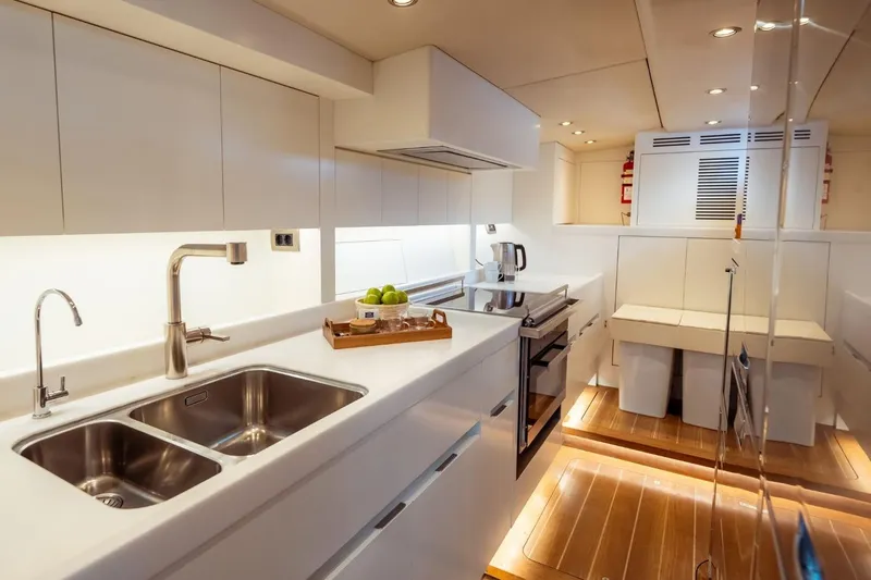 Ikigai Yacht Photos Pics Luxurious kitchen interior of 2002 JFA/Vitters 82 yacht with modern amenities and sleek design.