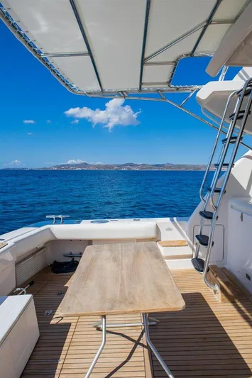  Yacht Photos Pics Bertram 570 yacht deck, 2006 model, with ocean view and clear blue sky.