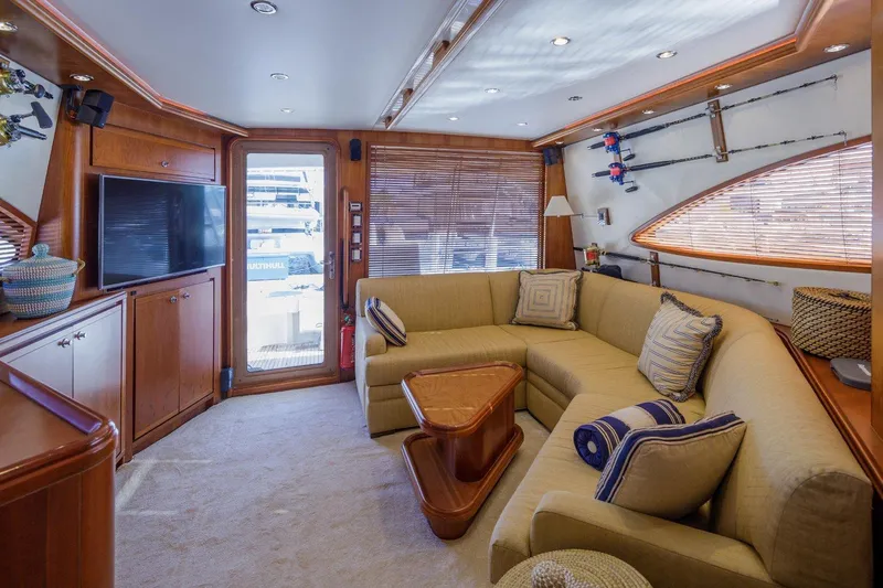  Yacht Photos Pics Luxurious interior of a 2006 Bertram 570 yacht with plush seating and elegant wood finishes.