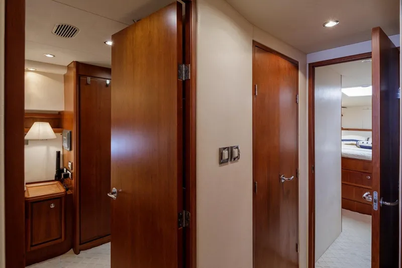  Yacht Photos Pics Interior of 2006 Bertram 570 yacht with wooden doors and cozy lighting.
